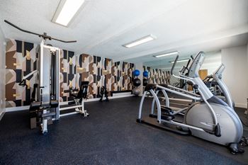 A gym with treadmills and other exercise equipment